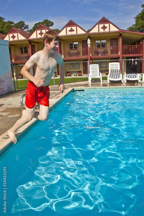 boy is jumping into the pool Stock Photo | Adobe Stock