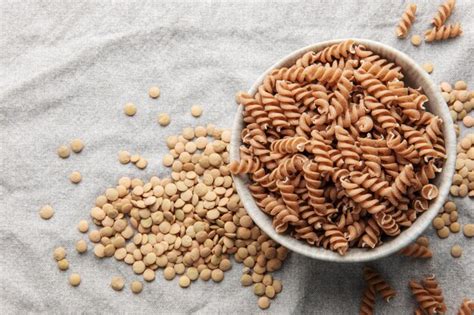 Premium Photo Green Lentil Fusilli Pasta On A Gray Textile Background