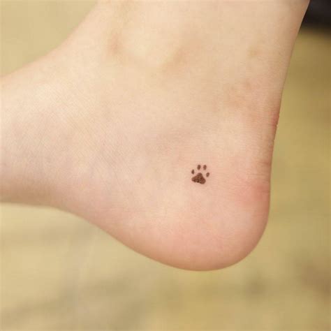 Minimalist dog paw tattoo