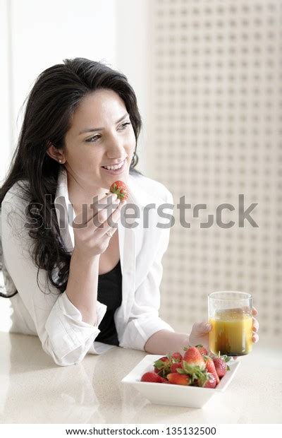 Attractive Young Woman Enjoying Fresh Fruit Stock Photo 135132500