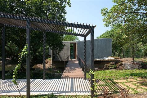 Steel Bridge Over Stream Connects Private And Public Areas Of Home