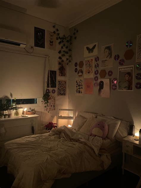 A Dimly Lit Bedroom With Many Pictures On The Wall And Lights In The