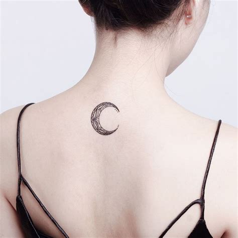 A Woman With A Crescent Tattoo On Her Back