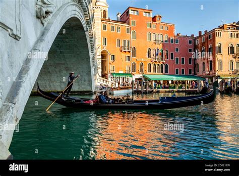 A Couple Take A Romantic Gondola Ride On The Grand Canal Venice Italy