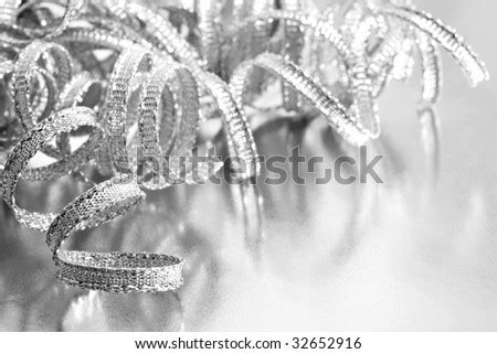 Shiny Silver Curling Ribbon On Reflective Wrapping Paper. High Key Black And White Macro With ...