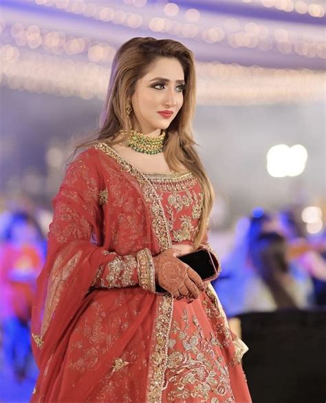 A Woman In A Red Bridal Outfit