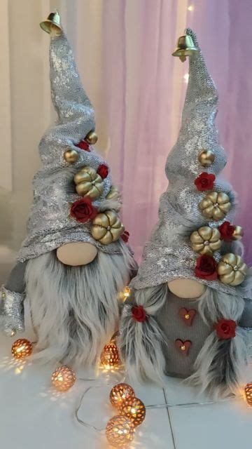 Two Gnomes Are Dressed In Silver And Gold Hats With Roses On Their