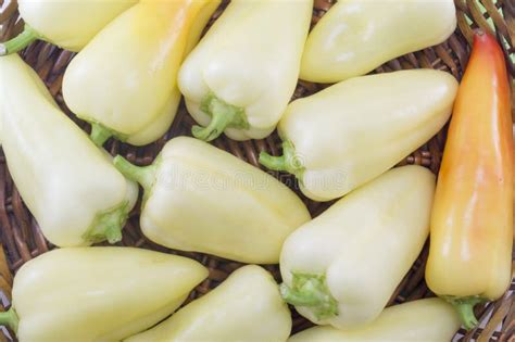 Natural Green And Orange Chili Peppers Arranged On A Wooden Plate Stock