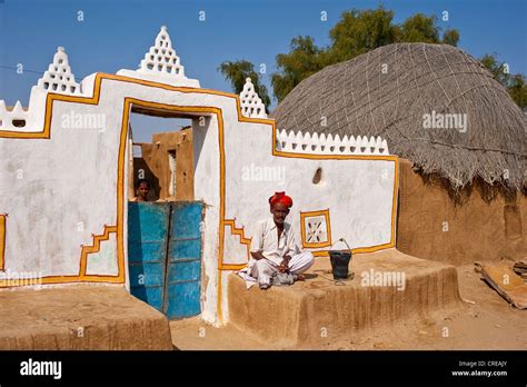 Rajasthani Indian Man Wearing A Dhoti And Turban Sitting In Front Of