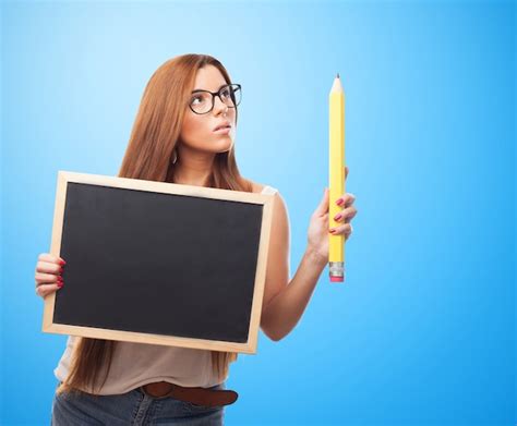 Free Photo Sensual Woman Holding Blackboard And Big Pencil