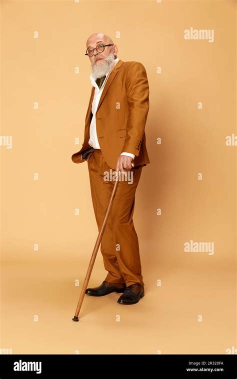 Full Length Portrait Of Bearded Mature Bald Man In Elegant Classical