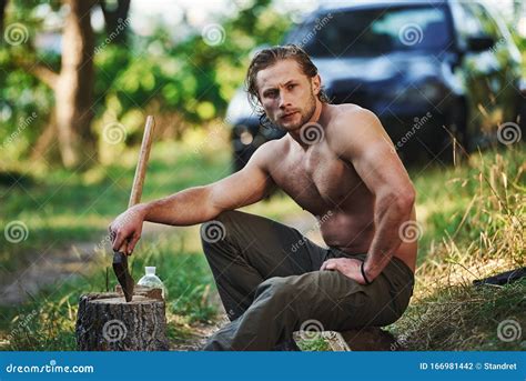 Holds Wooden Axe Handsome Shirtless Man With Muscular Body Type Is In