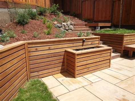 Pressure treated retaining wall with horizontal redwood facing ...