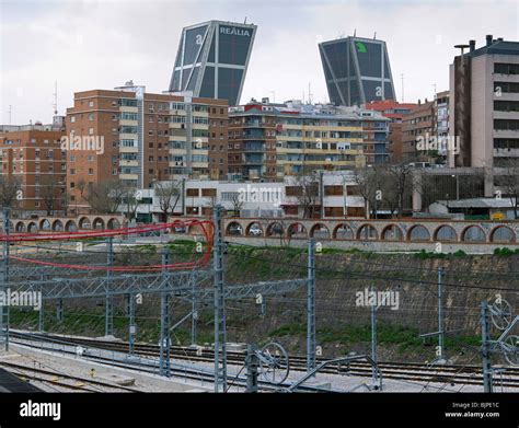 Train Tracks And Catenary At The Madrid Chamartin Station With The Kio