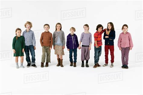 Nine kids standing in a row - Stock Photo - Dissolve