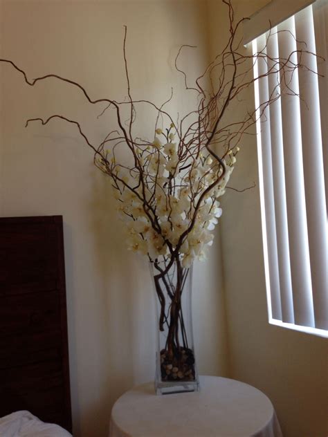 Silk Ivory Orchids With Large Branches In A Tall Rectangular Vase With