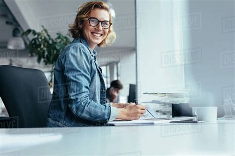 Female Manager Working At Her Desk Smiling Businesswoman Sitting In