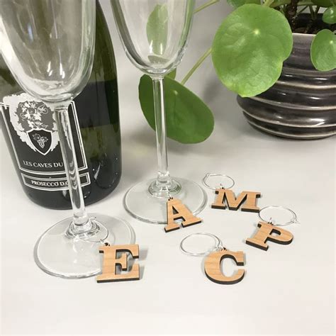 Wine Glasses And Wooden Letters Sitting Next To Each Other