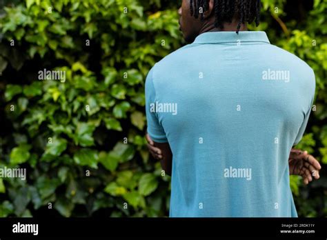 Rear View Of African American Man With Dreadlocks Wearing Pale Blue