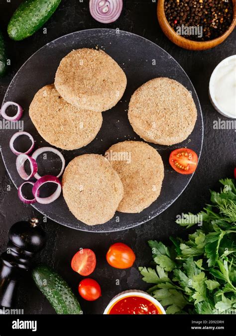 Fresh Pork Cutlets With Vegetables On The Background Stock Photo Alamy