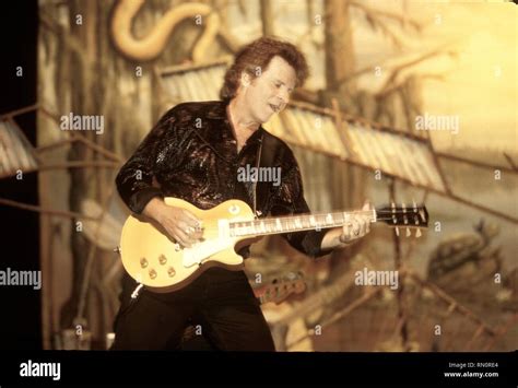 Singer, songwriter and guitarist John Fogerty is shown performing on stage during a live concert ...