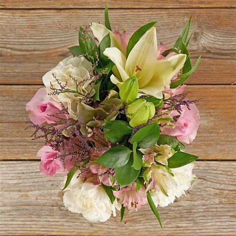 White Asiatic Lilies And Carnations With Light Pink Roses The Bouqs Co