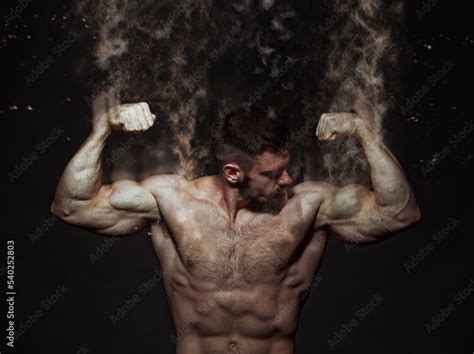 Muscle Shirtless Bodybuilder Flexing His Biceps Disintegrating Into