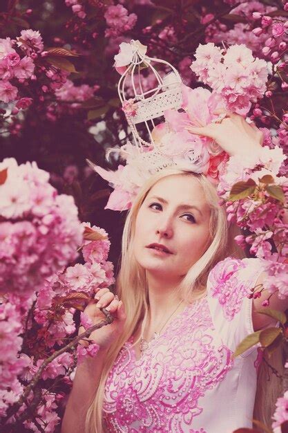 Premium Photo Beautiful Woman In Pink Dress Standing By Cherry