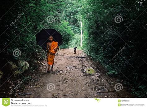 Buddhist Monk Walking Home With An Umbrella Editorial Stock Photo