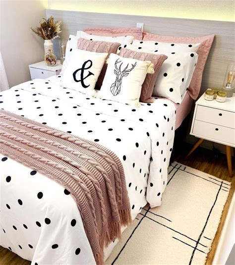 A Bed With Black And White Polka Dots On It Along With Two Decorative