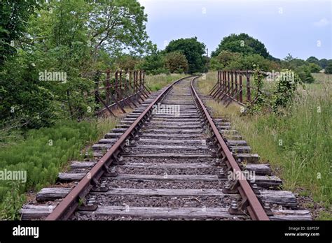 A Disused Train Track Runs Through The North Norfolk Countryside In