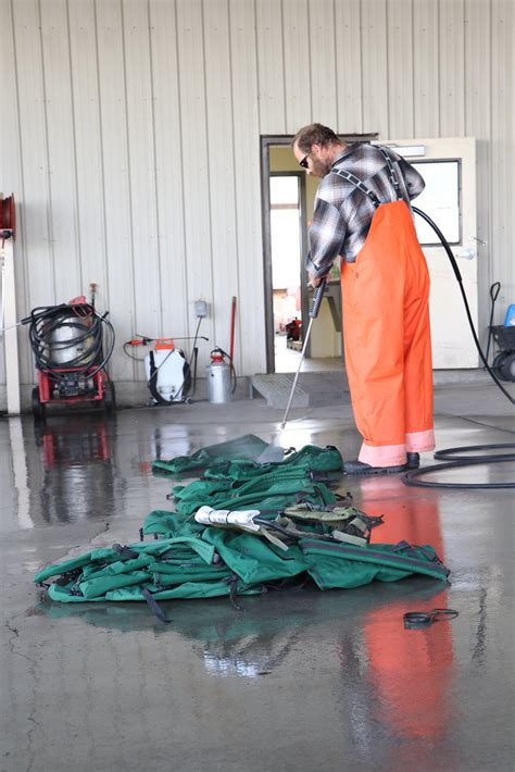 Returns Warehouse Employee Is Rinsing Off Gear Used On A F