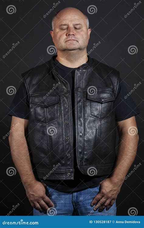 Adult Brutal Bald Man In A Leather Jacket Dark Background Stock Image