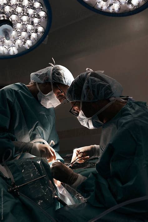 Team Of Surgeons Operating In The Hospital By Stocksy Contributor