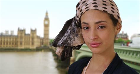 Close Up Of Cute Latina Woman In Stylish Headscarf Smiling Near Big Ben