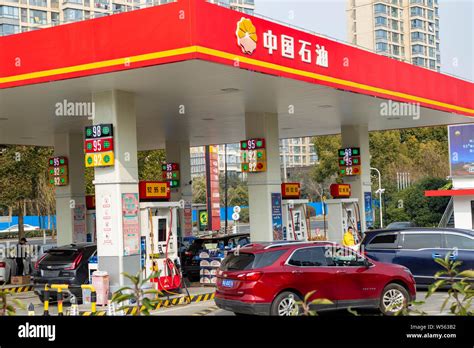 File Cars Queue Up To Be Refueled In Front Of A Gas Station Of