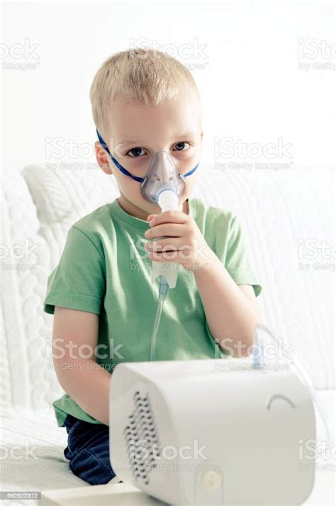 Boy Making Inhalation With Nebulizer At Home Stock Photo Download