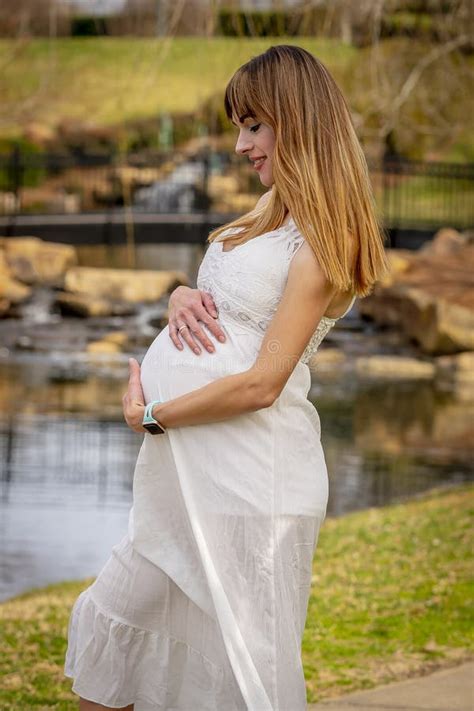 A Gorgeous Glowing Pregnant Woman Poses In An Outdoor Environment Stock Image Image Of