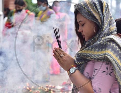 Image Of Devotees Stand In Queue Outside A Ganesh Temple To Offer