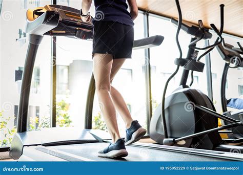 Legs Of Asian Girl Walking Using Treadmills To Warm Up Before Running