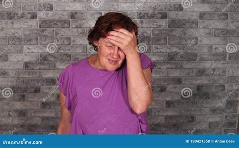 A Beautiful Mature Woman In Casual Clothes Is Doing Facepalm Covering