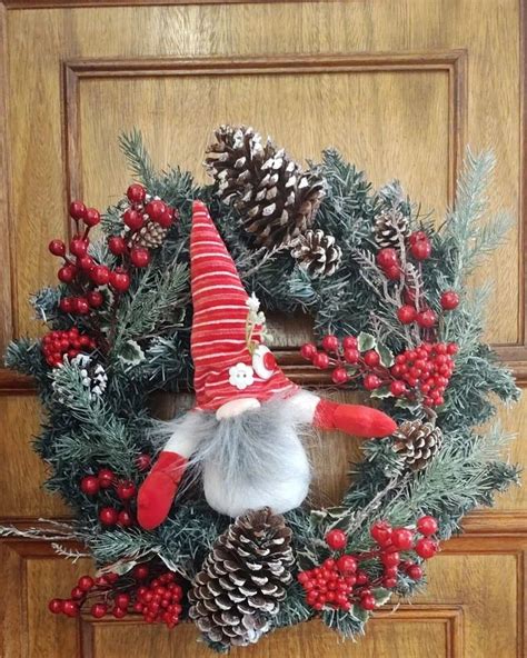 A Christmas Wreath With An Elf S Hat On It