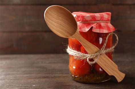 Premium Photo Jar Of Canned Tomatoes On Wooden Background