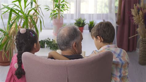 Grandpa Reading Story Books To His Grandchildren The Grandchildren