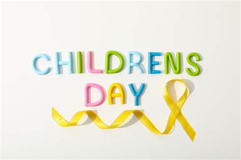 Premium Photo The Inscription Childrens Day With A Yellow Ribbon