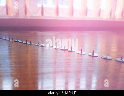 Diagonal office pins on the table bokeh backdrop Stock Photo - Alamy