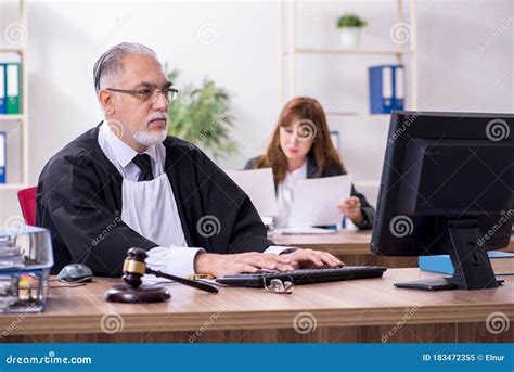 Old Male Judge And His Young Secretary In The Office Stock Image