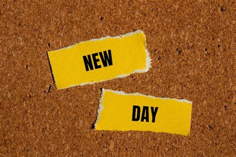 Premium Photo New Day Words Written On Ripped Yellow Paper With Brown Background