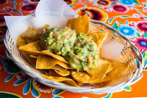 Premium Photo | Nachos with guacamole and cheese are a dish of mexican origin.