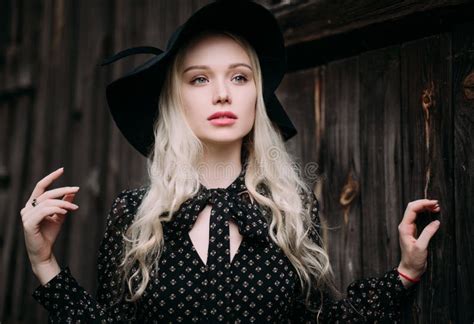 Beautiful Attractive And Stylish Girl Wearing Black Hat Standing Posing In City Nude Makeup